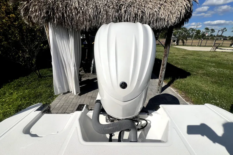 Slide: The Image of 2022 Cobalt R6 Outboard boat engine under a thatched roof, surrounded by greenery. - 31