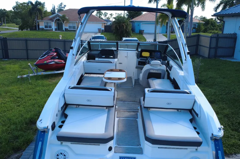 Slide: The Image of 2022 Cobalt R6 Outboard boat with spacious seating and modern design in a residential driveway. - 19