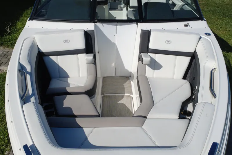 Slide: The Image of 2022 Cobalt R6 Outboard boat interior with white cushioned seating and modern design. - 26