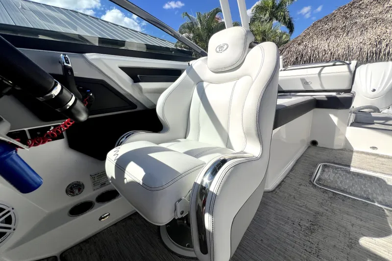 Slide: The Image of 2022 Cobalt R6 Outboard boat interior with luxurious white seating and modern dashboard. - 25