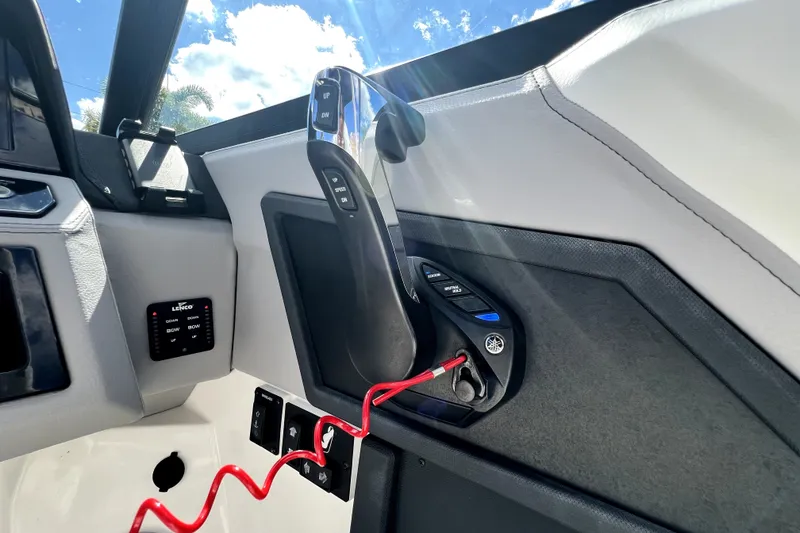 Slide: The Image of Control panel of 2022 Cobalt R6 Outboard boat with throttle and trim controls. - 93