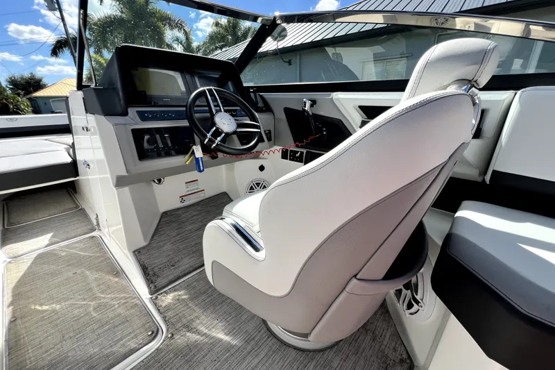 Slide: The Image of 2022 Cobalt R6 Outboard boat interior with steering wheel and captain's chair. - 53