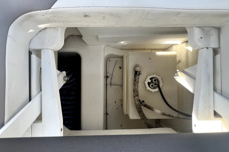 Slide: The Image of Interior view of a 2022 Cobalt R6 Outboard boat compartment with visible wiring and components. - 71