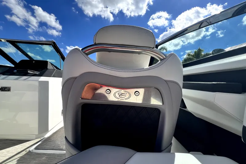Slide: The Image of 2022 Cobalt R6 Outboard boat interior with luxurious seating under a clear blue sky. - 94