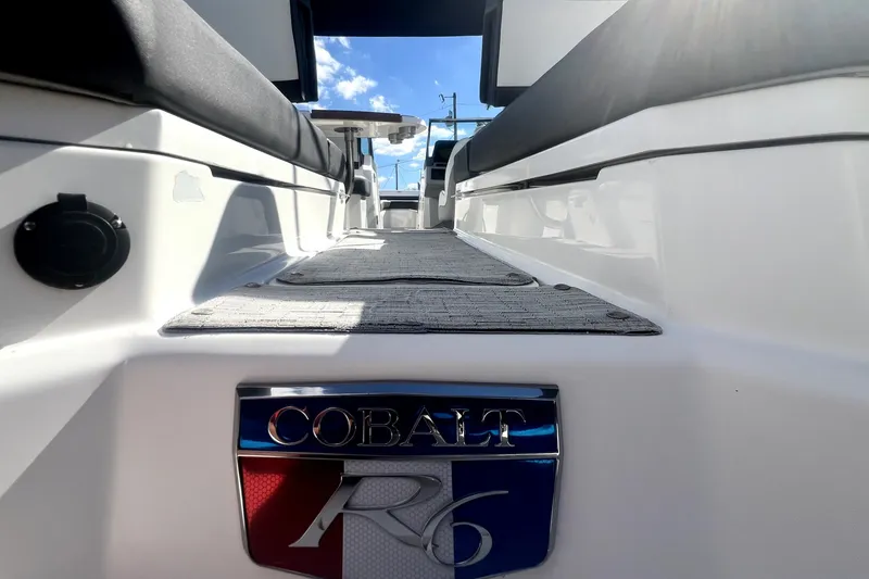 Slide: The Image of 2022 Cobalt R6 Outboard boat interior with logo, showcasing sleek design and seating. - 58