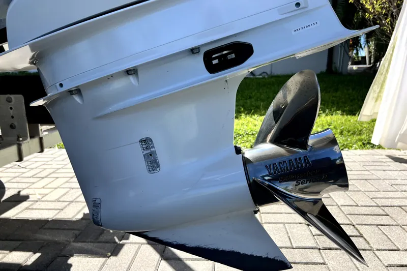 Slide: The Image of 2022 Cobalt R6 Outboard with Yamaha propeller on a paved surface. - 17