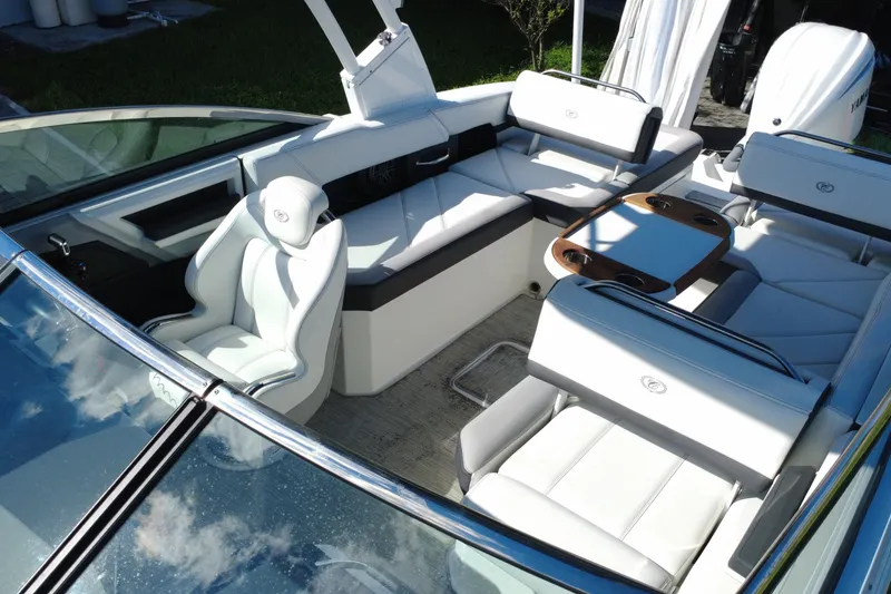 Slide: The Image of 2022 Cobalt R6 Outboard boat interior with luxurious white seating and sleek design. - 24