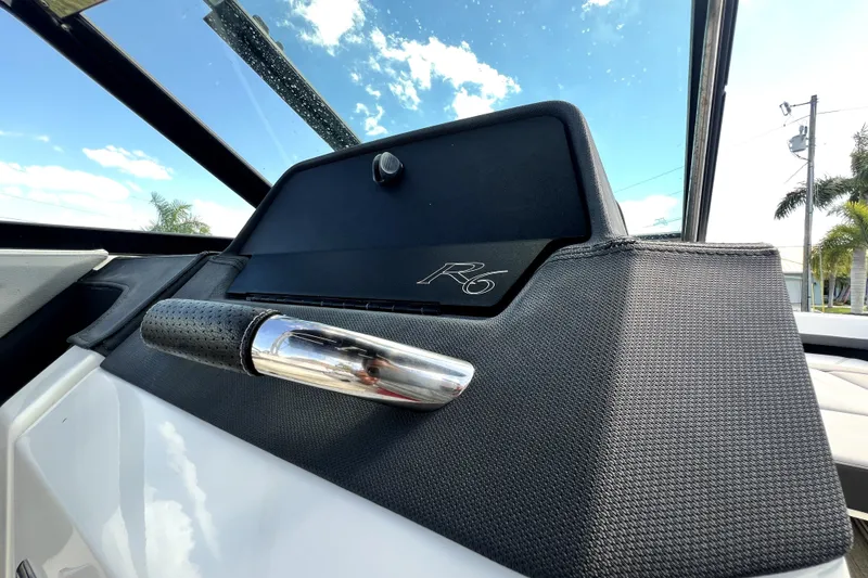 Slide: The Image of 2022 Cobalt R6 Outboard dashboard detail with textured handle and clear sky background. - 52