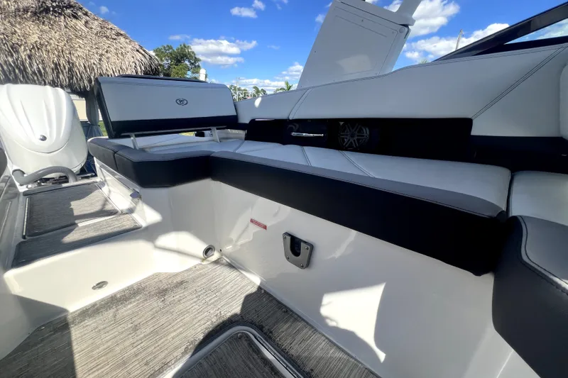 Slide: The Image of 2022 Cobalt R6 Outboard boat interior with sleek seating and modern design under blue sky. - 66