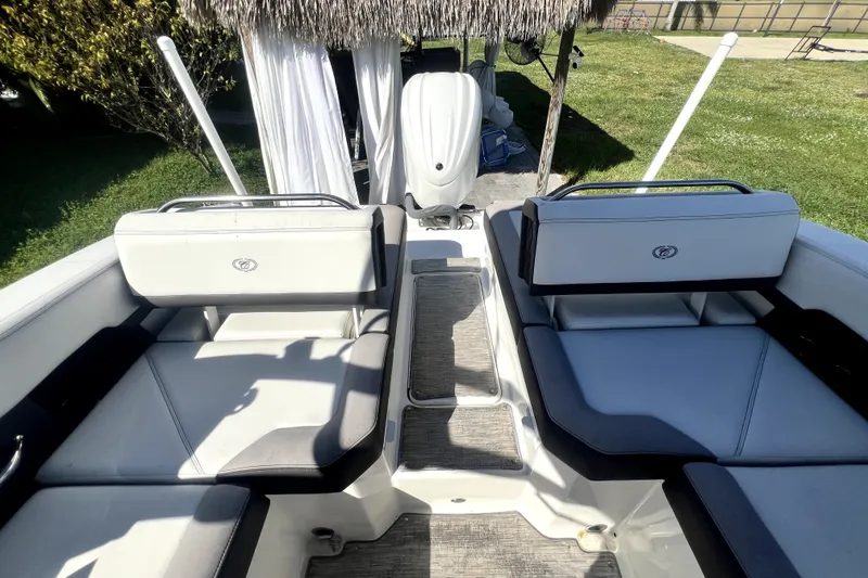 Slide: The Image of 2022 Cobalt R6 Outboard boat interior with cushioned seating and outboard motor. - 33