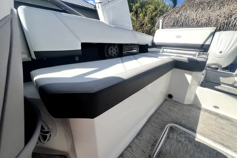 Slide: The Image of Interior seating of 2022 Cobalt R6 Outboard boat, featuring sleek white and black design. - 36