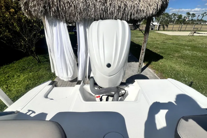 Slide: The Image of 2022 Cobalt R6 Outboard boat engine under a thatched canopy, sunny day. - 32