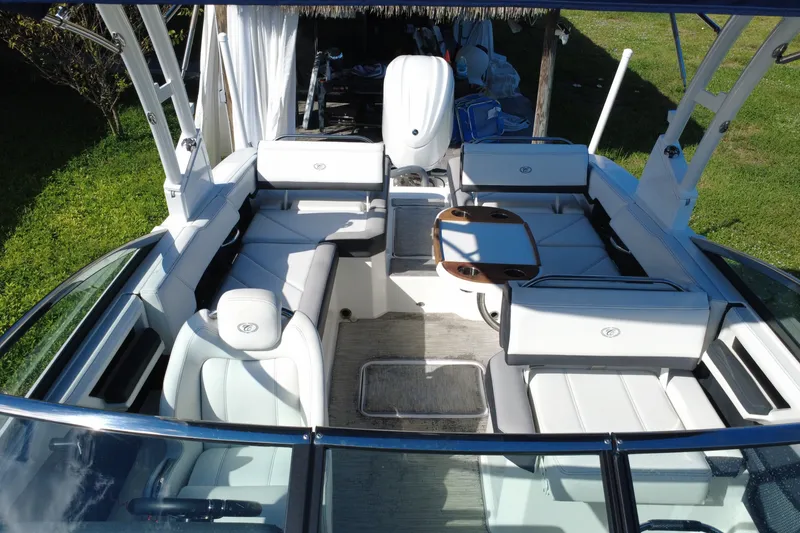 Slide: The Image of 2022 Cobalt R6 Outboard boat interior with white seating and wooden table. - 27