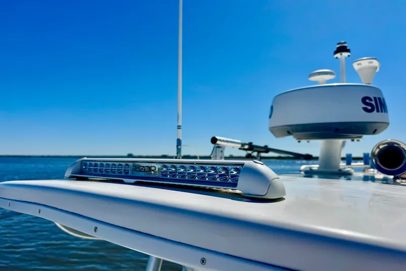 Slide: The Image of 2005 Regulator 32 Forward Seating boat with radar and light bar on open water. - 16