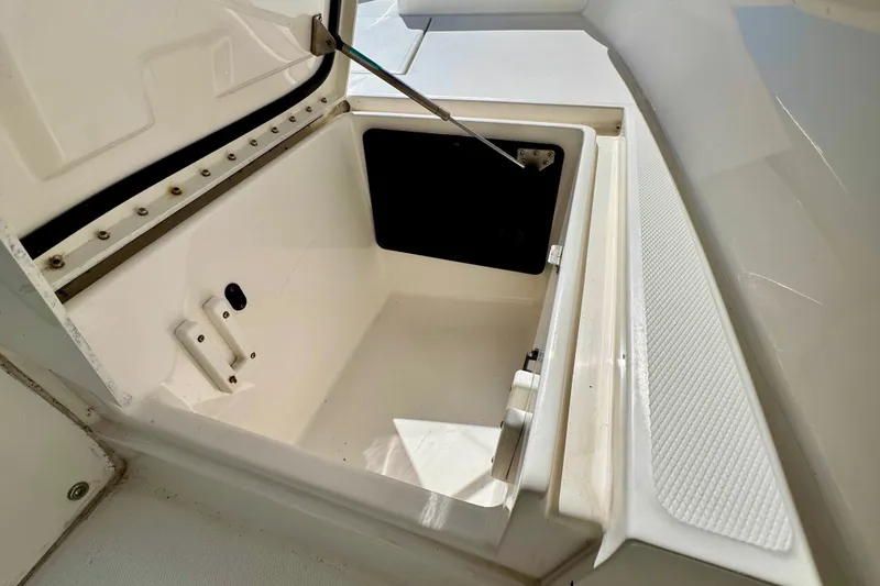 Slide: The Image of Open storage compartment on a 2005 Regulator 32 Forward Seating boat. - 26