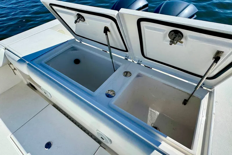 Slide: The Image of 2005 Regulator 32 Forward Seating boat with open storage compartments on deck. - 24