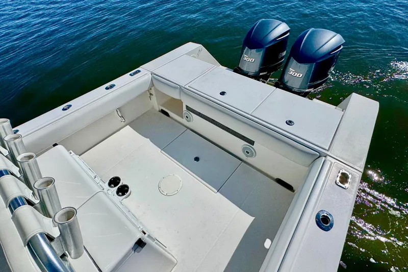 Slide: The Image of 2005 Regulator 32 Forward Seating boat with twin 300 horsepower engines on calm water. - 21