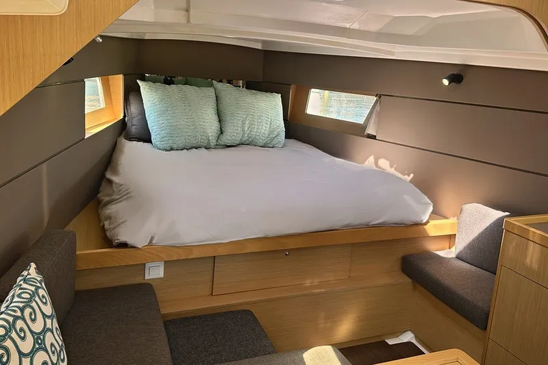Slide: The Image of Cozy cabin interior of 2014 Beneteau Oceanis 38 sailboat with bed and seating area. - 14