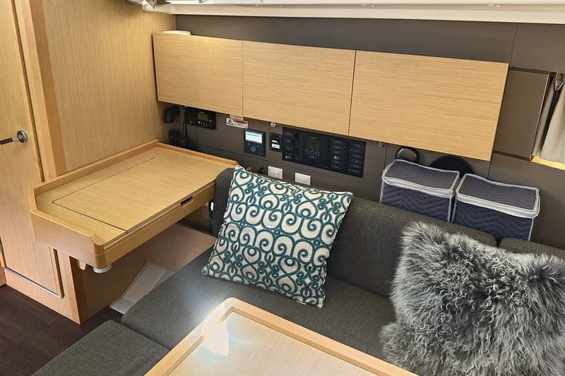 Slide: The Image of Interior of 2014 Beneteau Oceanis 38 yacht with cozy seating and modern wooden cabinetry. - 16