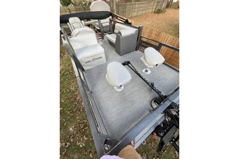 Slide: The Image of 2026 Lake Lounger 16' Front Fish Pro pontoon boat with seating and fishing setup. - 13