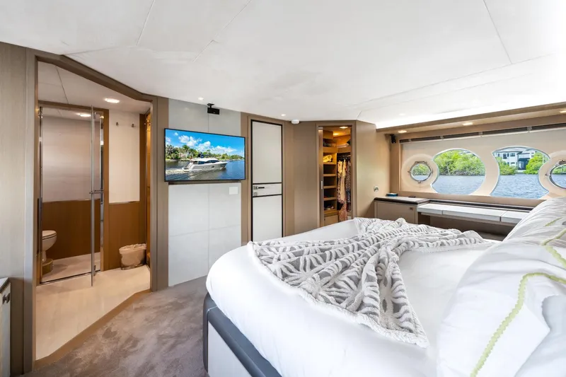 Slide: The Image of Luxurious 2015 Monte Carlo Yachts MCY 86 bedroom with ensuite, TV, and scenic window views. - 60