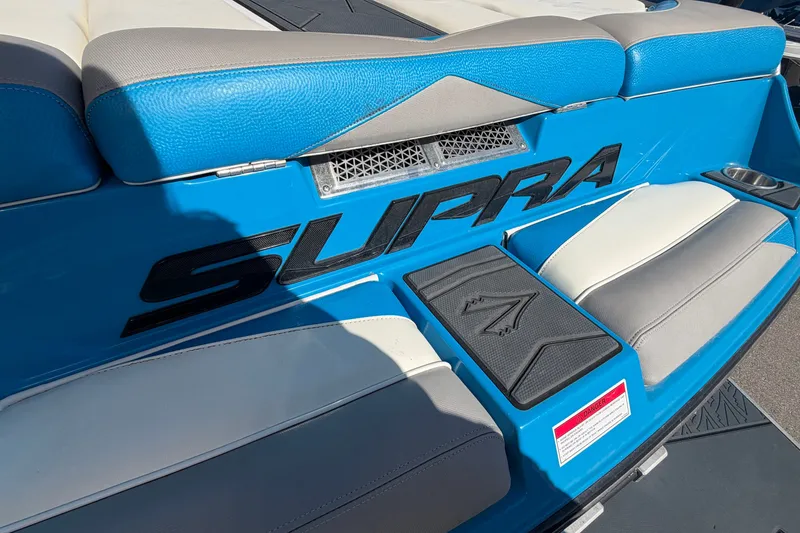 Slide: The Image of 2016 Supra SG 400-550 boat interior with blue and gray seating. - 16