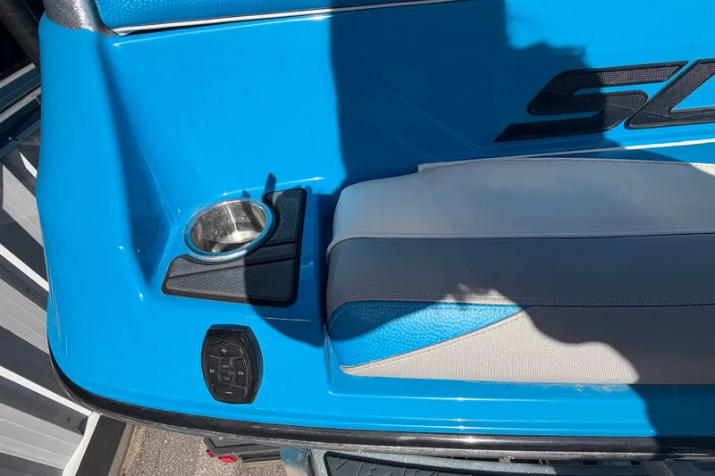 Slide: The Image of 2016 Supra SG 400-550 boat interior with blue and gray seating, cup holder, and control panel. - 15