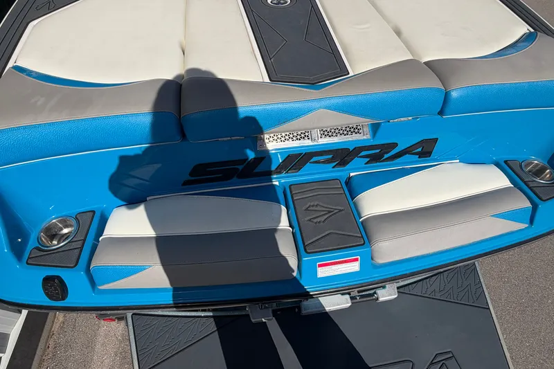 Slide: The Image of 2016 Supra SG 400-550 boat with blue and gray seating, shadow visible. - 14