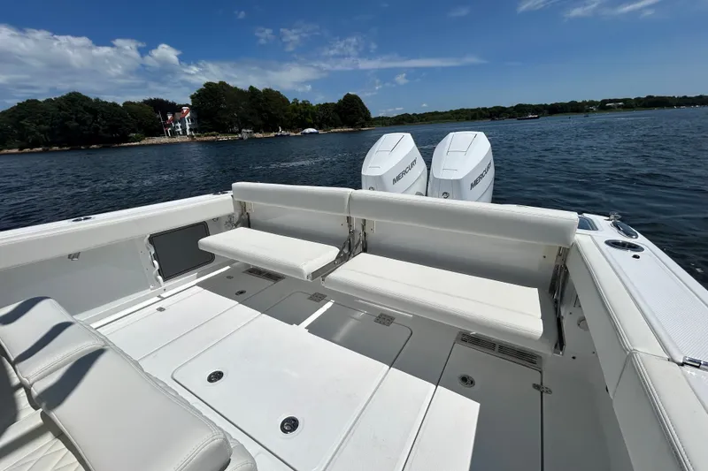 Slide: The Image of 2027 Everglades 315 Center Console boat with dual Mercury engines on a scenic lake. - 20