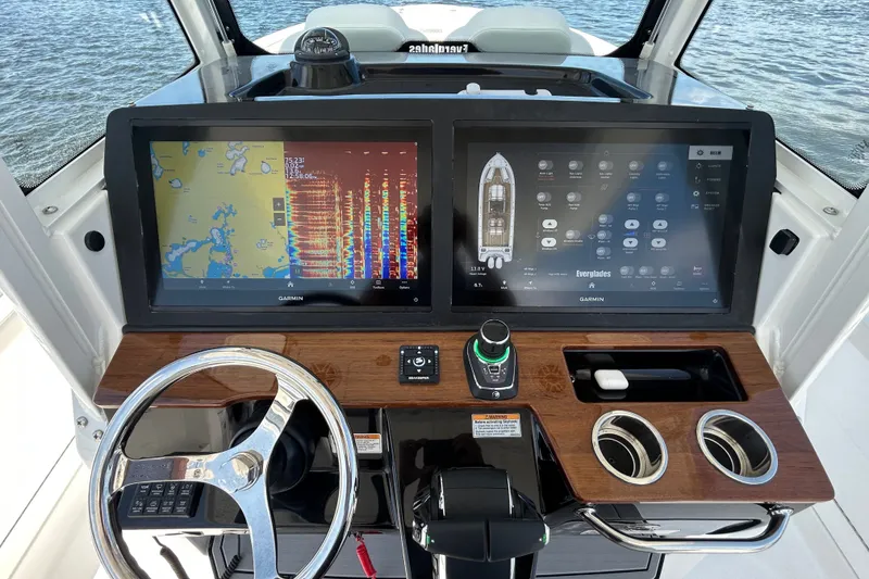 Slide: The Image of 2027 Everglades 315 Center Console dashboard with dual Garmin displays and modern controls. - 25