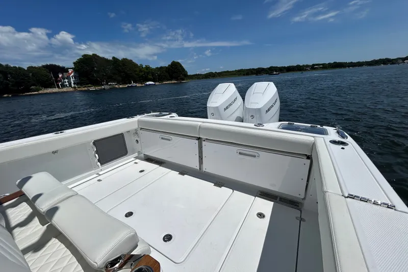 Slide: The Image of 2027 Everglades 315 Center Console boat on water, featuring dual Mercury engines. - 19