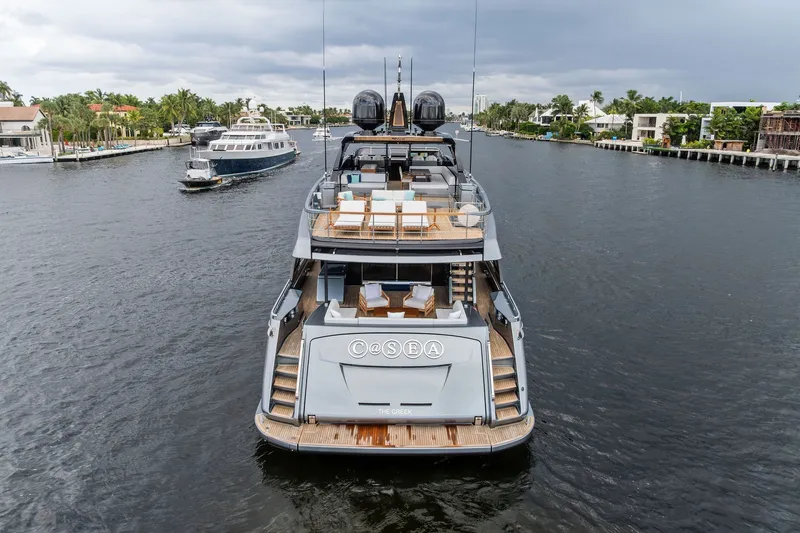 Slide: The Image of Luxury 2022 Riva 110' Dolcevita yacht cruising on a scenic waterway. - 4