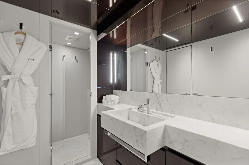 Slide: The Image of Luxurious bathroom on 2022 Riva 110' Dolcevita yacht with marble sink and robes. - 49