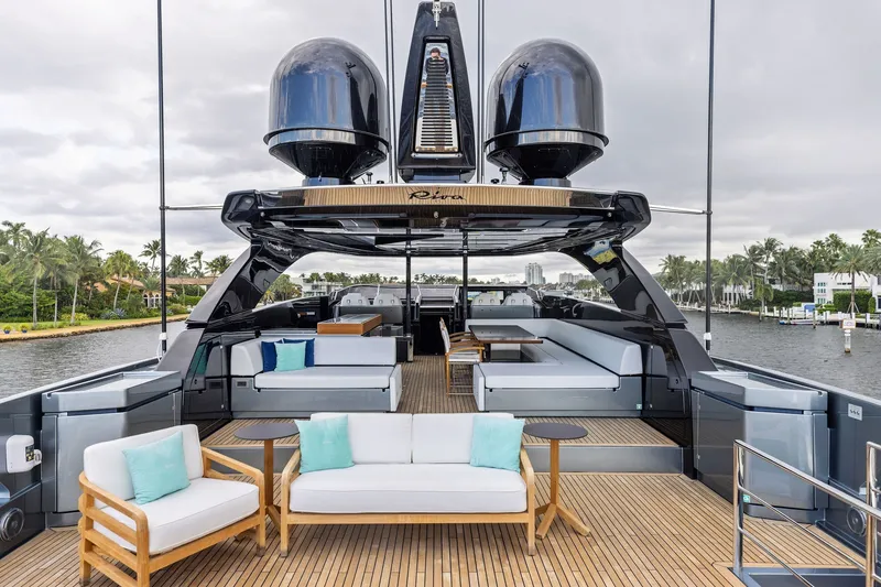 Slide: The Image of Luxurious 2022 Riva 110' Dolcevita yacht deck with elegant seating and scenic waterfront view. - 14