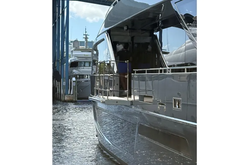 Slide: The Image of Luxury yacht Riva 110' Dolcevita 2022 docked at marina, reflecting sunlight. - 8