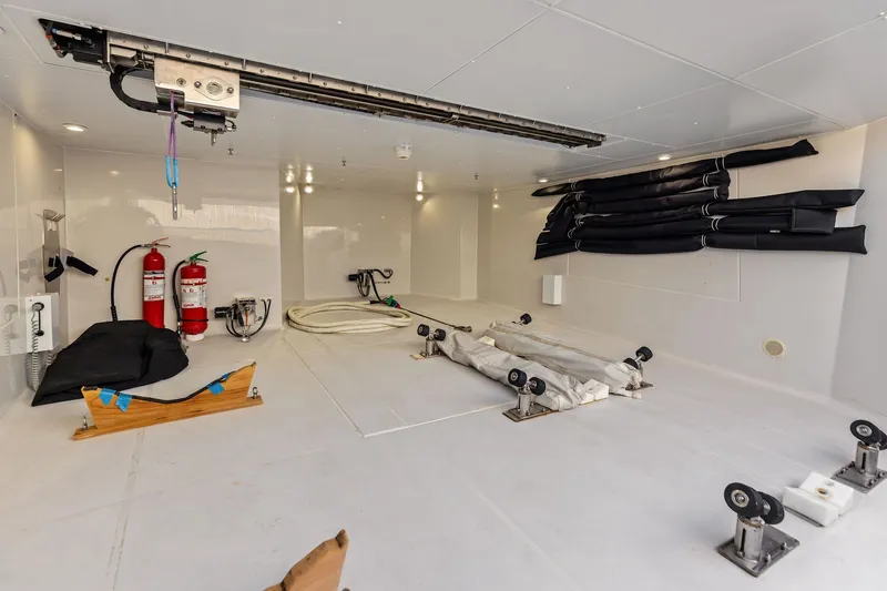Slide: The Image of Interior of 2022 Riva 110' Dolcevita yacht showing storage area with equipment and fire extinguishers. - 64