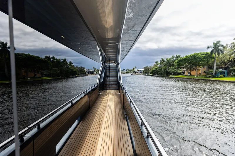 Slide: The Image of Side view of 2022 Riva 110' Dolcevita yacht on a serene waterway. - 7
