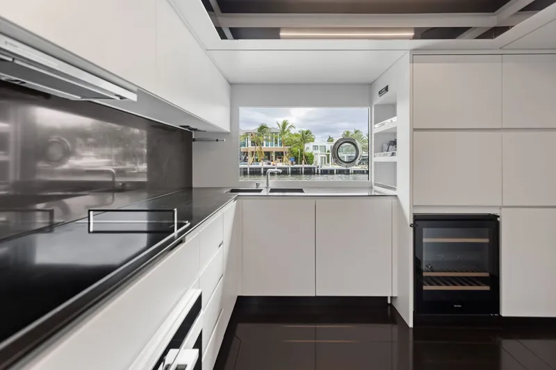 Slide: The Image of Modern kitchen interior on 2022 Riva 110' Dolcevita yacht, featuring sleek design and waterfront view. - 37