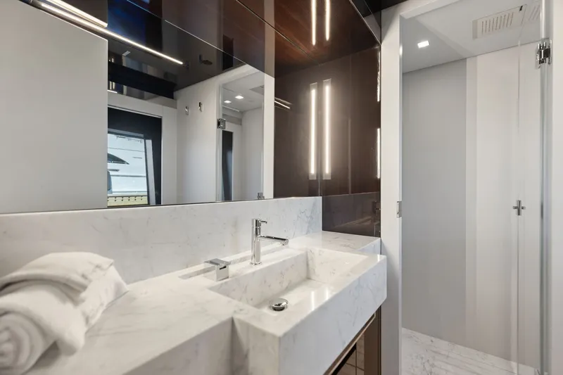 Slide: The Image of Luxurious bathroom interior on 2022 Riva 110' Dolcevita yacht, featuring marble sink and modern lighting. - 55