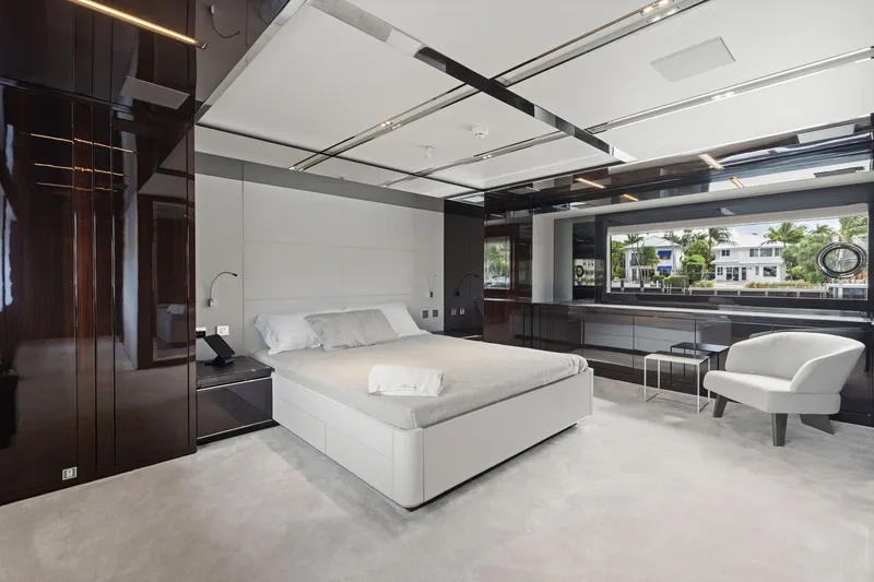 Slide: The Image of Luxurious bedroom interior on 2022 Riva 110' Dolcevita yacht, featuring modern design and large window view. - 39
