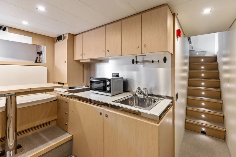 Slide: The Image of Modern kitchen interior on 2022 Riva 110' Dolcevita yacht, featuring sleek cabinetry and stainless steel sink. - 66