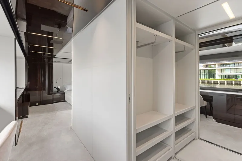Slide: The Image of Luxurious interior of 2022 Riva 110' Dolcevita yacht featuring modern closet and sleek design. - 46