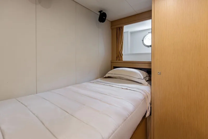 Slide: The Image of Luxurious cabin interior of 2022 Riva 110' Dolcevita yacht with single bed and porthole. - 68