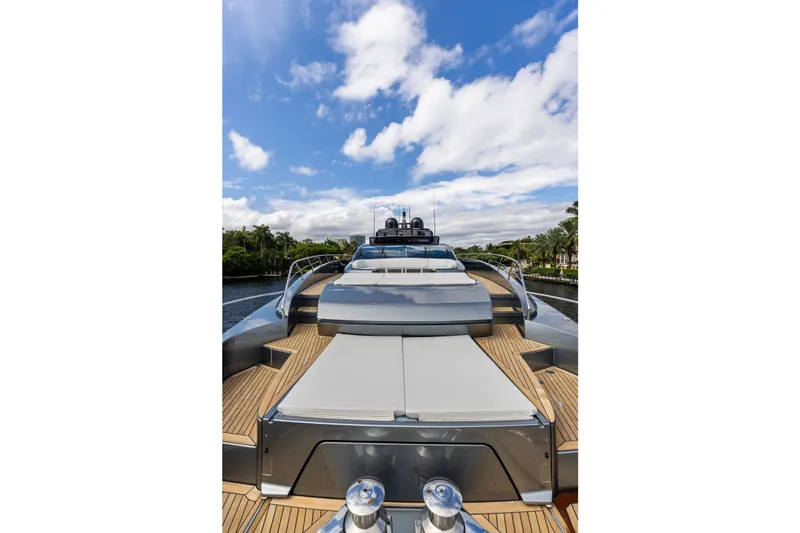 Slide: The Image of Luxurious 2022 Riva 110' Dolcevita yacht with sleek design and spacious deck under blue sky. - 12