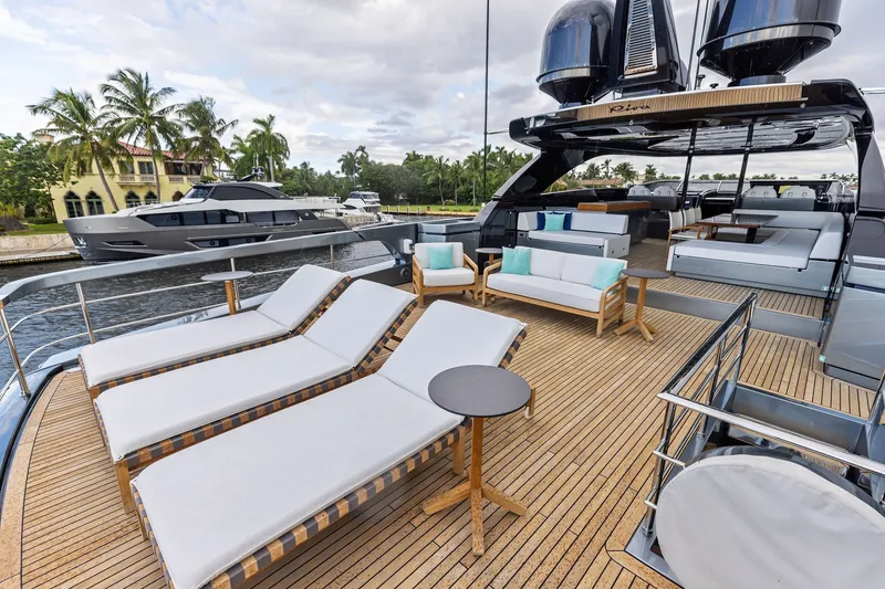Slide: The Image of Luxurious 2022 Riva 110' Dolcevita yacht deck with sun loungers and elegant seating. - 15