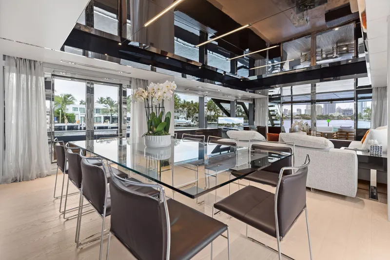 Slide: The Image of Luxurious interior of 2022 Riva 110' Dolcevita yacht with modern dining area and waterfront view. - 27