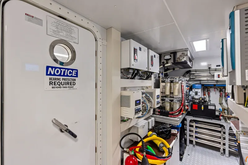 Slide: The Image of Engine room of 2022 Riva 110' Dolcevita yacht with safety notice and equipment. - 59