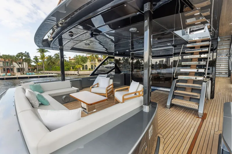 Slide: The Image of Luxurious 2022 Riva 110' Dolcevita yacht deck with elegant seating and staircase. - 22