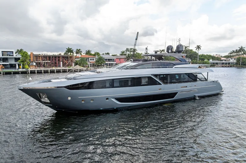 Slide: The Image of Luxury 2022 Riva 110' Dolcevita yacht cruising on a scenic waterfront. - 2