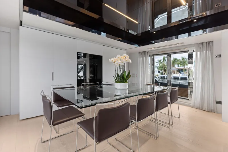 Slide: The Image of Luxurious dining area on 2022 Riva 110' Dolcevita yacht with glass table and elegant chairs. - 28